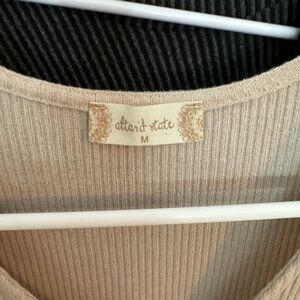 Very cute tan shirt looks brand new